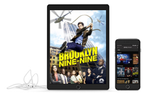 tablet showing brooklyn nine-nine next to phone and headphones
